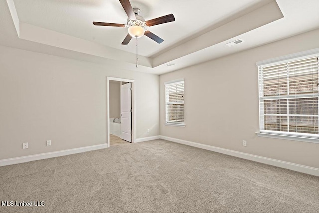 6743 Jessie Hoyt Dr, Olive Branch, MS 38654 - spare room with a tray ceiling, ceiling fan, light carpet, and baseboards