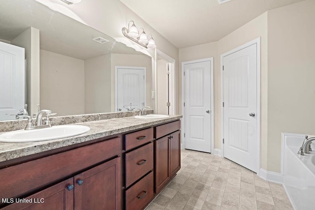 6743 Jessie Hoyt Dr, Olive Branch, MS 38654 - full bathroom with double vanity, baseboards, and a garden tub