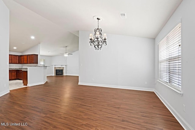 6743 Jessie Hoyt Dr, Olive Branch, MS 38654 - unfurnished living room featuring vaulted ceiling, a chandelier, a ceiling fan, dark wood finished floors, and baseboards