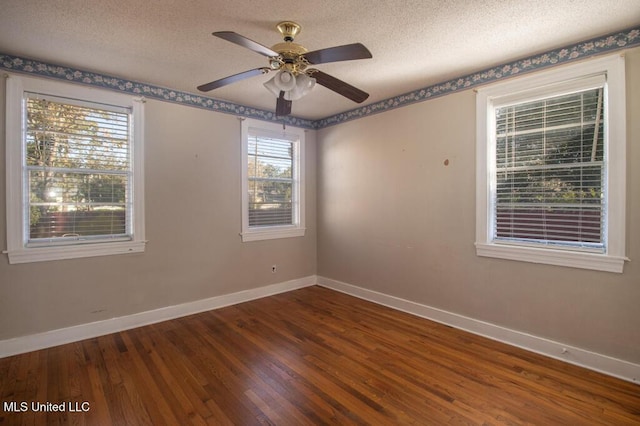 spare room with ceiling fan, dark hardwood / wood-style flooring, and a textured ceiling