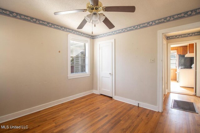 spare room featuring hardwood / wood-style floors and ceiling fan