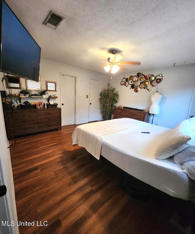 bedroom featuring dark wood-type flooring and a textured ceiling