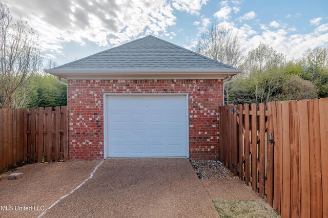 7199 Terrace Stone Dr, Olive Branch, MS 38654 - garage featuring aphalt driveway and fence