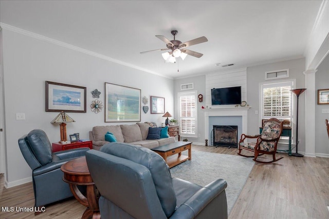 7199 Terrace Stone Dr, Olive Branch, MS 38654 - living area with a fireplace with flush hearth, ceiling fan, crown molding, and light wood finished floors