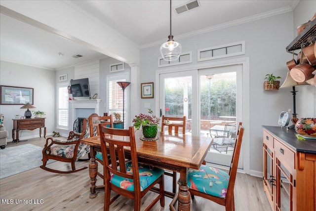 7199 Terrace Stone Dr, Olive Branch, MS 38654 - dining space featuring baseboards, ornamental molding, visible vents, and light wood-type flooring