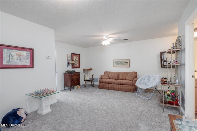 7199 Terrace Stone Dr, Olive Branch, MS 38654 - carpeted living room with baseboards, visible vents, ceiling fan, and a textured ceiling