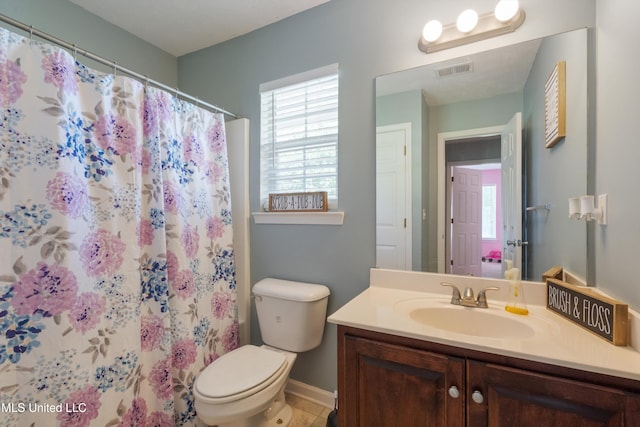 bathroom featuring toilet, vanity, baseboards, and a shower with curtain