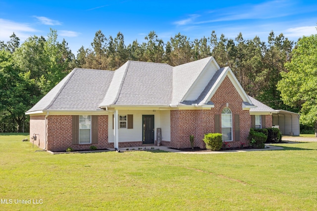 ranch-style home featuring brick siding, a front lawn, and a carport
