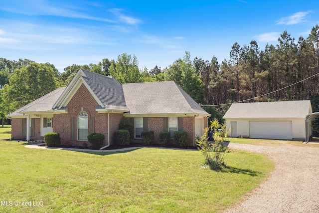 ranch-style house featuring driveway, a front yard, brick siding, an outdoor structure, and a garage