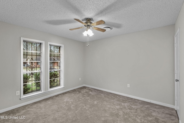 unfurnished room featuring a healthy amount of sunlight, carpet, and baseboards