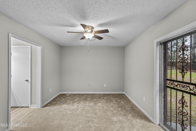 unfurnished room with ceiling fan, carpet floors, a textured ceiling, and baseboards