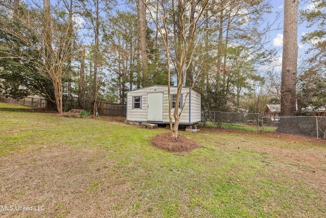 view of yard featuring an outbuilding, a shed, and a fenced backyard