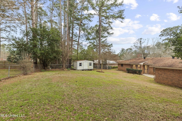 view of yard featuring a fenced backyard, a storage unit, and an outbuilding