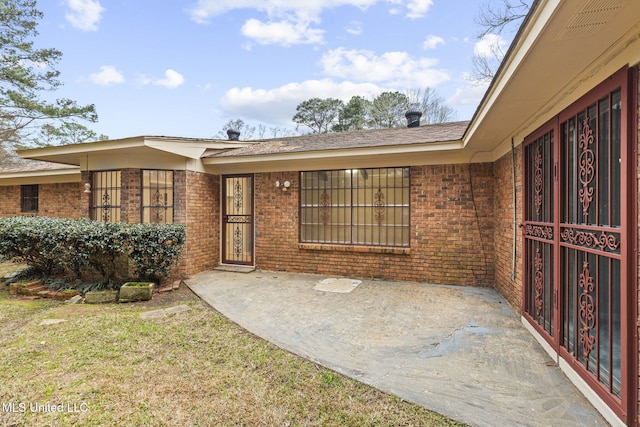 doorway to property with brick siding