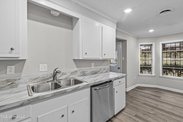 kitchen featuring dishwasher, light wood-style flooring, ornamental molding, white cabinetry, and a sink