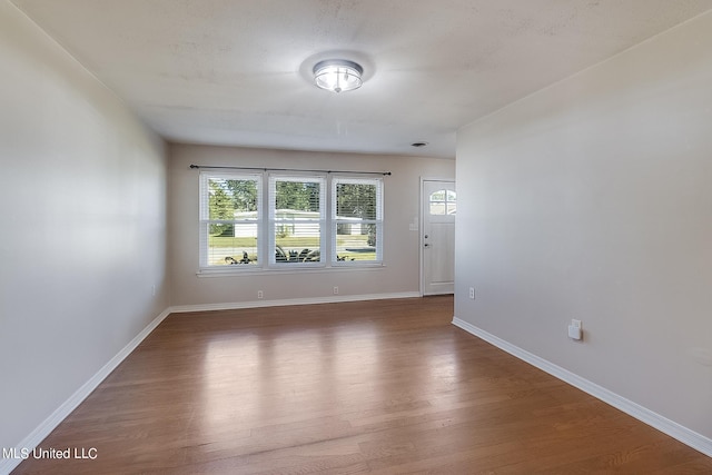 unfurnished room featuring dark hardwood / wood-style flooring