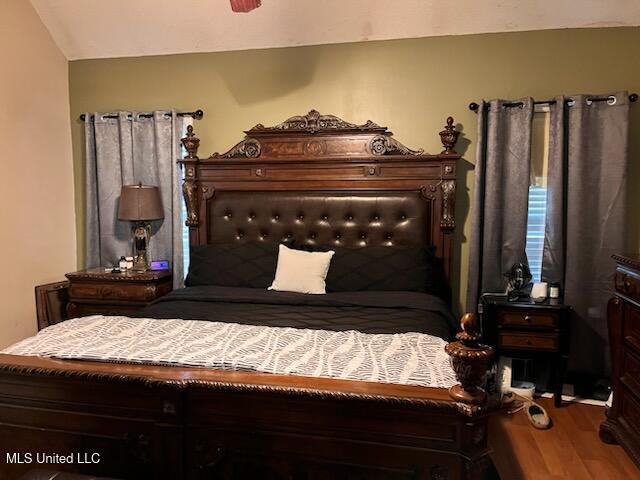 9091 Hunters Ridge Dr, Olive Branch, MS 38654 - bedroom featuring wood finished floors and lofted ceiling