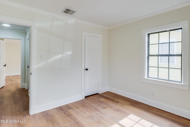 1018 27th St, Gulfport, MS 39501 - spare room with ornamental molding, light wood-style flooring, and baseboards