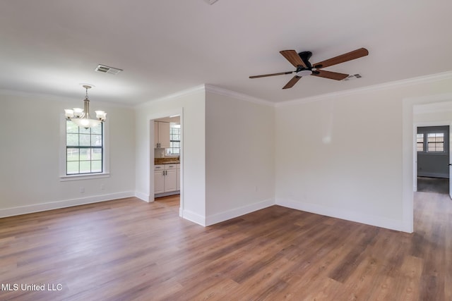 1018 27th St, Gulfport, MS 39501 - unfurnished room featuring a chandelier, plenty of natural light, a ceiling fan, ornamental molding, and wood finished floors