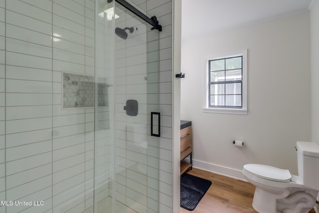 1018 27th St, Gulfport, MS 39501 - full bathroom with a stall shower, toilet, baseboards, wood finished floors, and ornamental molding
