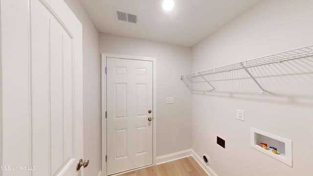 clothes washing area with electric dryer hookup, light wood-type flooring, and hookup for a washing machine