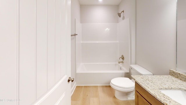 full bathroom featuring hardwood / wood-style floors, vanity, toilet, and shower / washtub combination