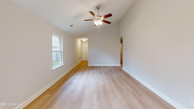 empty room featuring ceiling fan, light hardwood / wood-style floors, and lofted ceiling