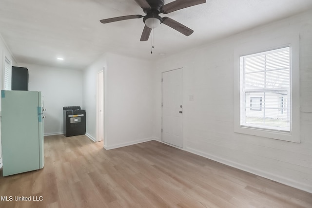 unfurnished room featuring light wood-style flooring and baseboards