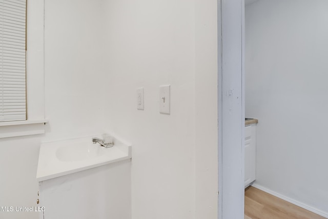 bathroom featuring wood finished floors and baseboards