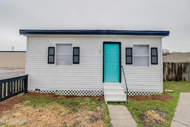 bungalow with entry steps, crawl space, and fence