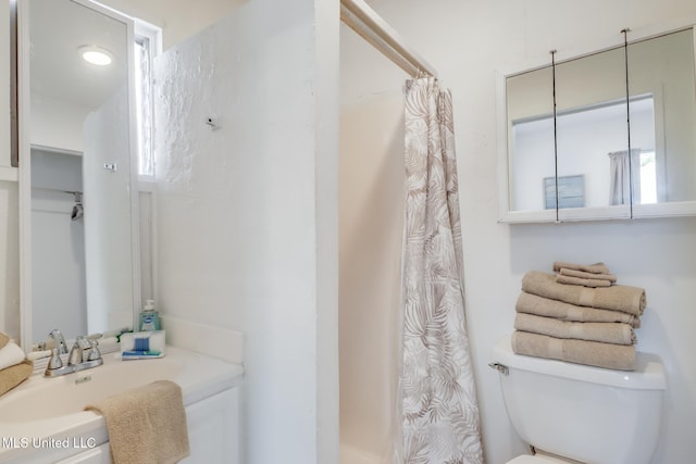 full bathroom featuring toilet, a sink, and curtained shower