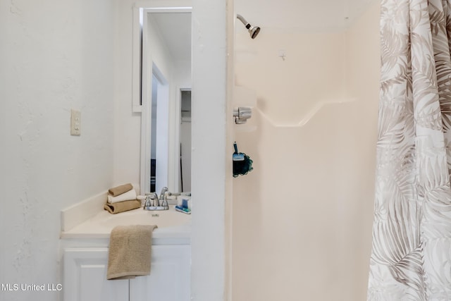 bathroom featuring vanity and a shower with shower curtain