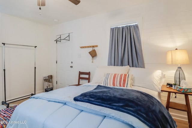 bedroom with a baseboard radiator and a ceiling fan