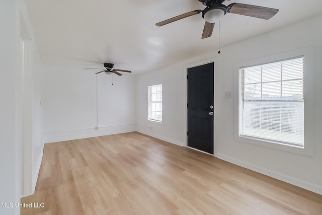 foyer featuring baseboards, ceiling fan, and light wood finished floors