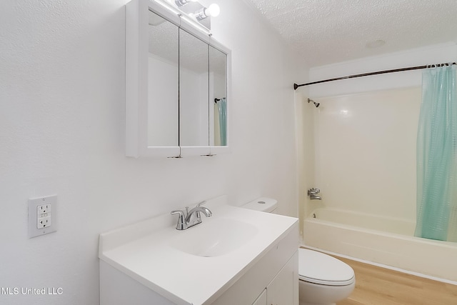 bathroom featuring a textured ceiling, toilet, wood finished floors, vanity, and shower / bathtub combination with curtain