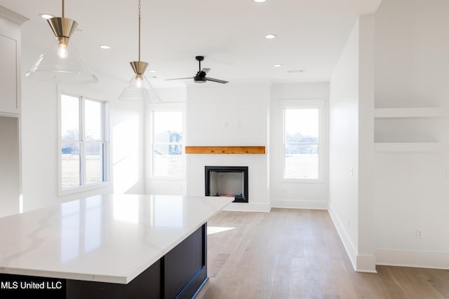 unfurnished living room with light hardwood / wood-style floors and ceiling fan