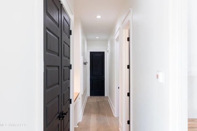 hall with light hardwood / wood-style floors