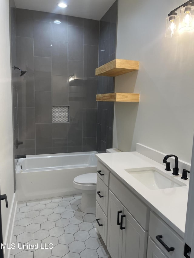 full bathroom with tile patterned flooring, vanity, toilet, and tiled shower / bath combo