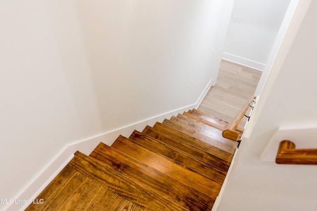 stairway with hardwood / wood-style floors