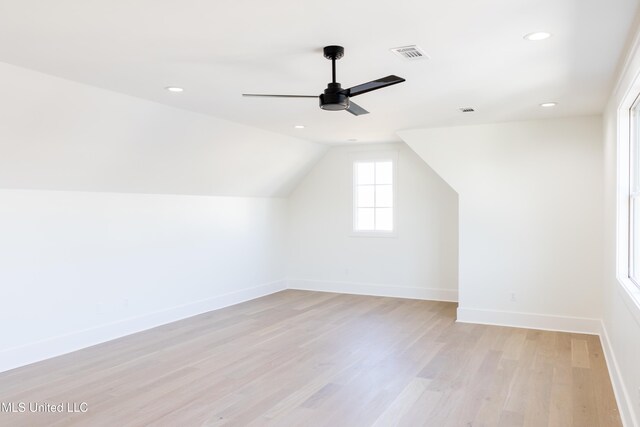 additional living space featuring ceiling fan, light hardwood / wood-style floors, and vaulted ceiling