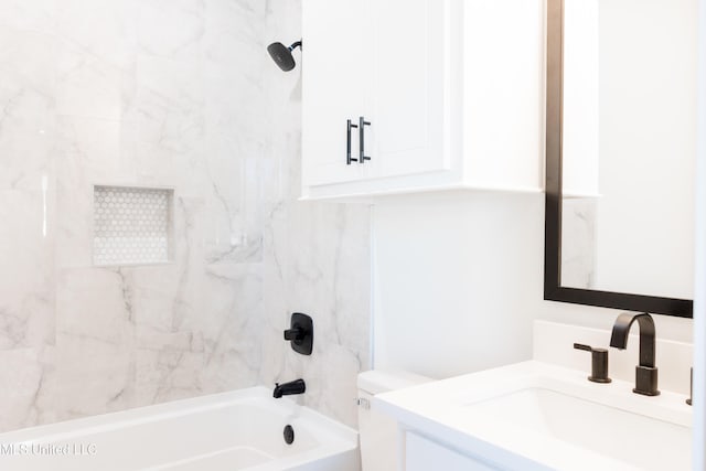 full bathroom featuring vanity, toilet, and tiled shower / bath