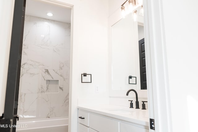 bathroom with vanity and a bath