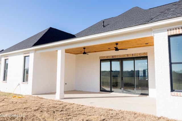 rear view of house with ceiling fan and a patio area