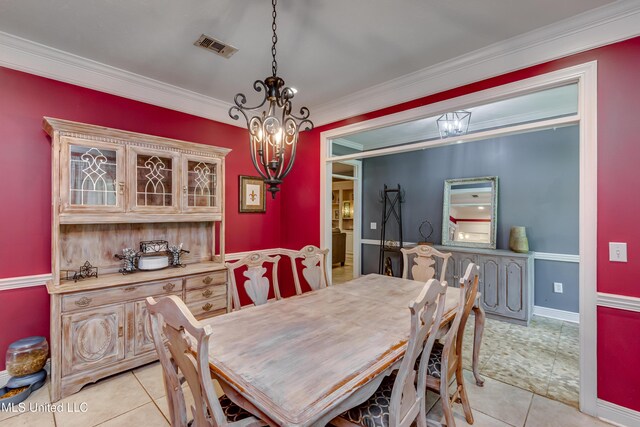 203 Remington Dr, Brandon, MS 39042 - dining room with crown molding, an inviting chandelier, baseboards, light tile patterned floors, and visible vents
