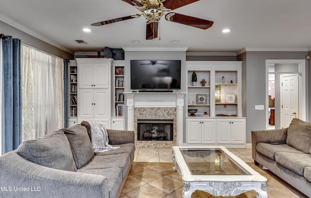 living area with crown molding, a ceiling fan, a tile fireplace, and light tile patterned flooring