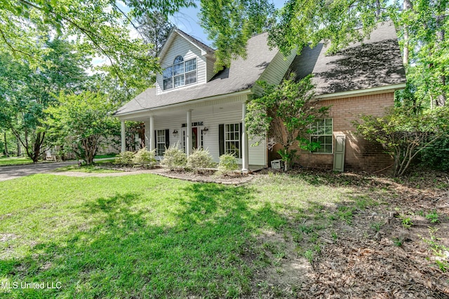 203 Remington Dr, Brandon, MS 39042 - view of front facade featuring a porch, brick siding, roof with shingles, and a front lawn