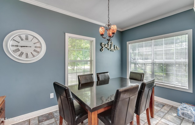 dining room featuring stone tile floors, baseboards, a chandelier, and crown molding