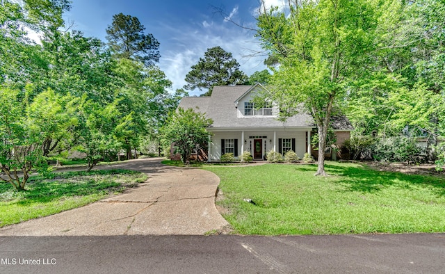 cape cod home with covered porch and a front lawn