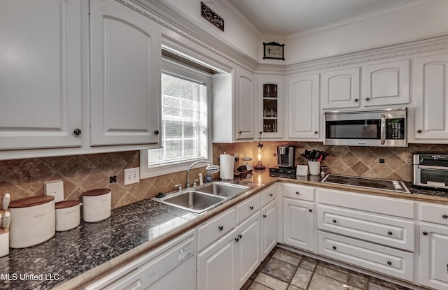 kitchen featuring a sink, black electric cooktop, stainless steel microwave, and white cabinets