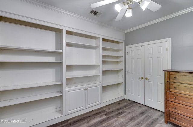 spacious closet featuring visible vents, a ceiling fan, and dark wood-style flooring